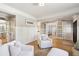 Bright living room featuring white slipcovered armchairs and barn doors at 2737 Sarazen Dr, Mount Pleasant, SC 29466