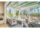 Relaxing sunroom with comfortable seating, a fireplace, and serene wooded views at 2737 Sarazen Dr, Mount Pleasant, SC 29466