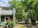 A partially shaded backyard with mature trees and plants, as well as a screened in porch at 2757 Jobee Dr # 1101, Charleston, SC 29414