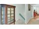 Home hallway with antique curio cabinet and view into another room at 2757 Jobee Dr # 1101, Charleston, SC 29414
