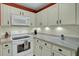 White kitchen with white appliances and terracotta-colored wall at 2757 Jobee Dr # 1101, Charleston, SC 29414