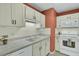 White kitchen with white appliances and terracotta-colored wall at 2757 Jobee Dr # 1101, Charleston, SC 29414
