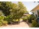 Relaxing patio area with seating amidst a beautifully landscaped garden at 302 Minus St, Saint George, SC 29477