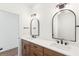 Bathroom with dual vanities, arched mirrors, and wood cabinets at 3917 Delinger Dr, Mount Pleasant, SC 29466