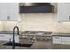 Modern kitchen features a black range hood, stainless steel appliances, and dark countertops at 3917 Delinger Dr, Mount Pleasant, SC 29466