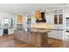 Open concept kitchen with an island, white cabinets, and hardwood floors at 3917 Delinger Dr, Mount Pleasant, SC 29466