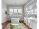 Elegant bathroom with soaking tub, double vanity, and hardwood floors at 4001 Palm Blvd, Isle of Palms, SC 29451