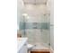 Spa-like bathroom with glass shower, marble tile, and modern fixtures at 4001 Palm Blvd, Isle of Palms, SC 29451