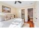 King bedroom with en-suite bathroom and hardwood floors at 4001 Palm Blvd, Isle of Palms, SC 29451