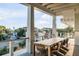 Outdoor deck with dining table and chairs, beautiful view at 4001 Palm Blvd, Isle of Palms, SC 29451