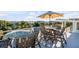 Relaxing ocean view deck featuring wooden patio furniture at 4001 Palm Blvd, Isle of Palms, SC 29451