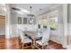 Elegant dining room with a large wooden table and white upholstered chairs at 4001 Palm Blvd, Isle of Palms, SC 29451