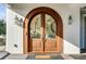 Elegant arched double front door with glass panels at 4001 Palm Blvd, Isle of Palms, SC 29451