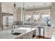 Bright kitchen with white cabinets, large island, and stainless steel appliances at 4001 Palm Blvd, Isle of Palms, SC 29451