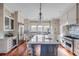Gourmet kitchen features a large island, stainless steel appliances, and white cabinetry at 4001 Palm Blvd, Isle of Palms, SC 29451
