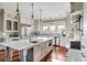 Bright kitchen with white cabinets, large island, and stainless steel appliances at 4001 Palm Blvd, Isle of Palms, SC 29451