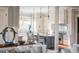 Open kitchen with white cabinets, island, and hardwood floors at 4001 Palm Blvd, Isle of Palms, SC 29451