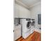 Bright laundry room with washer, dryer, and cabinets at 4001 Palm Blvd, Isle of Palms, SC 29451