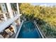 Elevated pool with surrounding deck and lush landscaping at 4001 Palm Blvd, Isle of Palms, SC 29451