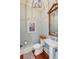Stylish powder room with pedestal sink and hardwood floors at 4001 Palm Blvd, Isle of Palms, SC 29451