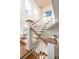 Bright, open staircase with white railings and hardwood treads at 4001 Palm Blvd, Isle of Palms, SC 29451