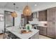 Modern kitchen with island, stainless steel appliances, and wicker pendants at 5 Gadsdenboro St # 410, Charleston, SC 29401