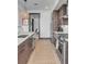 Modern kitchen island with stainless steel appliances and wood flooring at 5 Gadsdenboro St # 410, Charleston, SC 29401