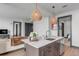 Modern kitchen island with white quartz countertops and dark brown cabinets at 5 Gadsdenboro St # 410, Charleston, SC 29401