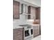 Sleek kitchen with stainless steel appliances and dark wood cabinets at 5 Gadsdenboro St # 410, Charleston, SC 29401