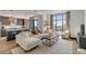 Bright living room with comfy sectional sofa, large windows, and city view at 5 Gadsdenboro St # 410, Charleston, SC 29401