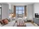 Spacious living area featuring large windows and city views at 5 Gadsdenboro St # 410, Charleston, SC 29401