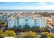 Oceanfront community view, featuring a light blue building and lush landscaping at 5804 Palmetto Dr # A-405/407, Isle of Palms, SC 29451