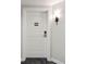 White apartment door with a simple design and a numbered placard at 5804 Palmetto Dr # A-405/407, Isle of Palms, SC 29451