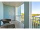 Private balcony with wicker chairs and scenic wooded views at 5804 Palmetto Dr # A-405/407, Isle of Palms, SC 29451