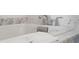 Relaxing bathroom featuring a soaking tub and marble countertop at 5804 Palmetto Dr # A-405/407, Isle of Palms, SC 29451