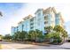 Luxury building in coastal setting with palm trees at 5804 Palmetto Dr # A-405/407, Isle of Palms, SC 29451