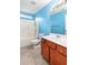 Bathroom with tub shower combo and wood cabinets at 7468 Northgate Dr, Hanahan, SC 29410