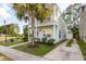 Two-story house with light green siding, a porch, and palm tree at 7468 Northgate Dr, Hanahan, SC 29410