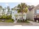 Charming two-story light green house with palm tree and walkway at 7468 Northgate Dr, Hanahan, SC 29410