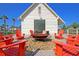 Outdoor fire pit with bright orange Adirondack chairs at a community clubhouse perfect for relaxing at 760 Myrtle Branch St, Summerville, SC 29486