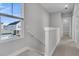 Upstairs hallway with carpet, railing, and window overlooking backyard at 760 Myrtle Branch St, Summerville, SC 29486