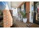 Inviting front porch with rocking chairs and brick columns at 9504 Markley Blvd, Summerville, SC 29485