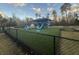 Community playground with various play structures, pond, and safety fencing at 9504 Markley Blvd, Summerville, SC 29485