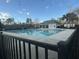 Outdoor community swimming pool with fenced perimeter, and pool house with clear, blue water at 9504 Markley Blvd, Summerville, SC 29485