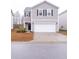Two-story house with gray siding, white garage door, and landscaping at 9806 Sickle Dr, Ladson, SC 29456
