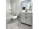 Clean bathroom with white vanity, marble-tiled floor, and bathtub at 100 Del Ray Dr, Walterboro, SC 29488