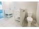 Modern bathroom with double vanity, toilet and white tile flooring at 101 Brien, Walterboro, SC 29488