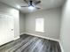 Bright bedroom with ceiling fan and grey vinyl plank flooring at 101 Brien, Walterboro, SC 29488