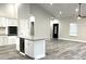 Open concept kitchen with island, granite countertops, and grey vinyl plank flooring at 101 Brien, Walterboro, SC 29488
