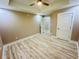 A neutral-toned bedroom featuring a ceiling fan, light hardwood floors, and two white doors at 1034 Weeks Lane, Round O, SC 29474